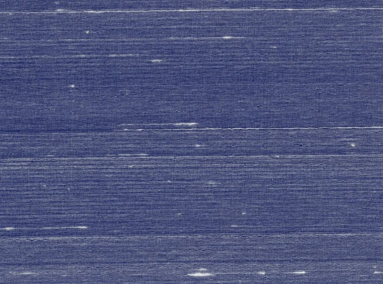 Close-up of a deep blue silk wallcovering with fine white slub threads across the weave