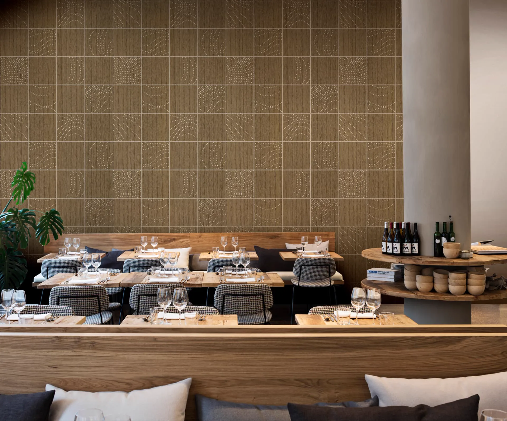 Restaurant wall clad in square Wood Veneer panels, laser engraved with flowing dotted patterns, above banquette seating and set tables