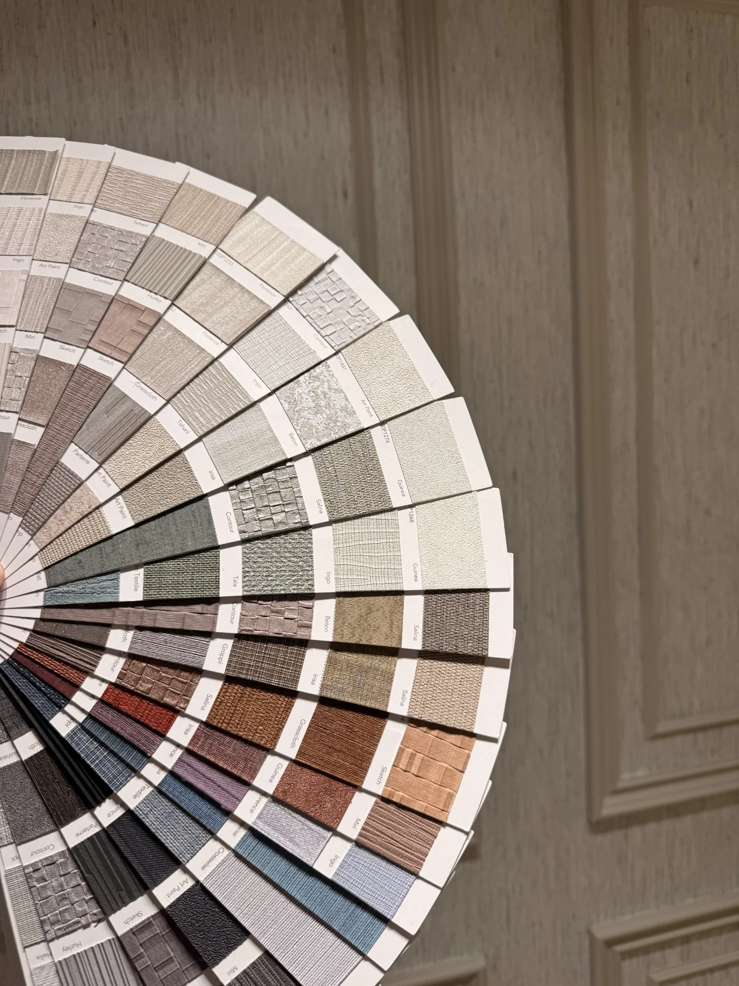 A Performance Vinyl fan deck opened out to show a wide range of textured finishes, from pale neutrals to deep blues and terracotta