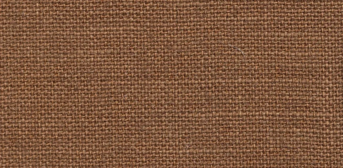 Close-up of a warm brown jute wallcovering showing its open, even basket weave and fine loose fibres