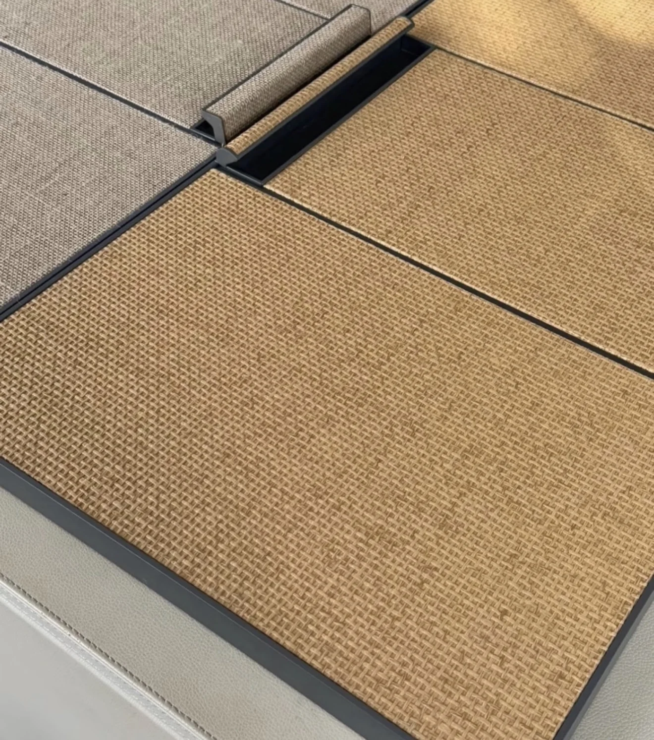 Framed furniture panels faced with tan and grey woven wallcoverings