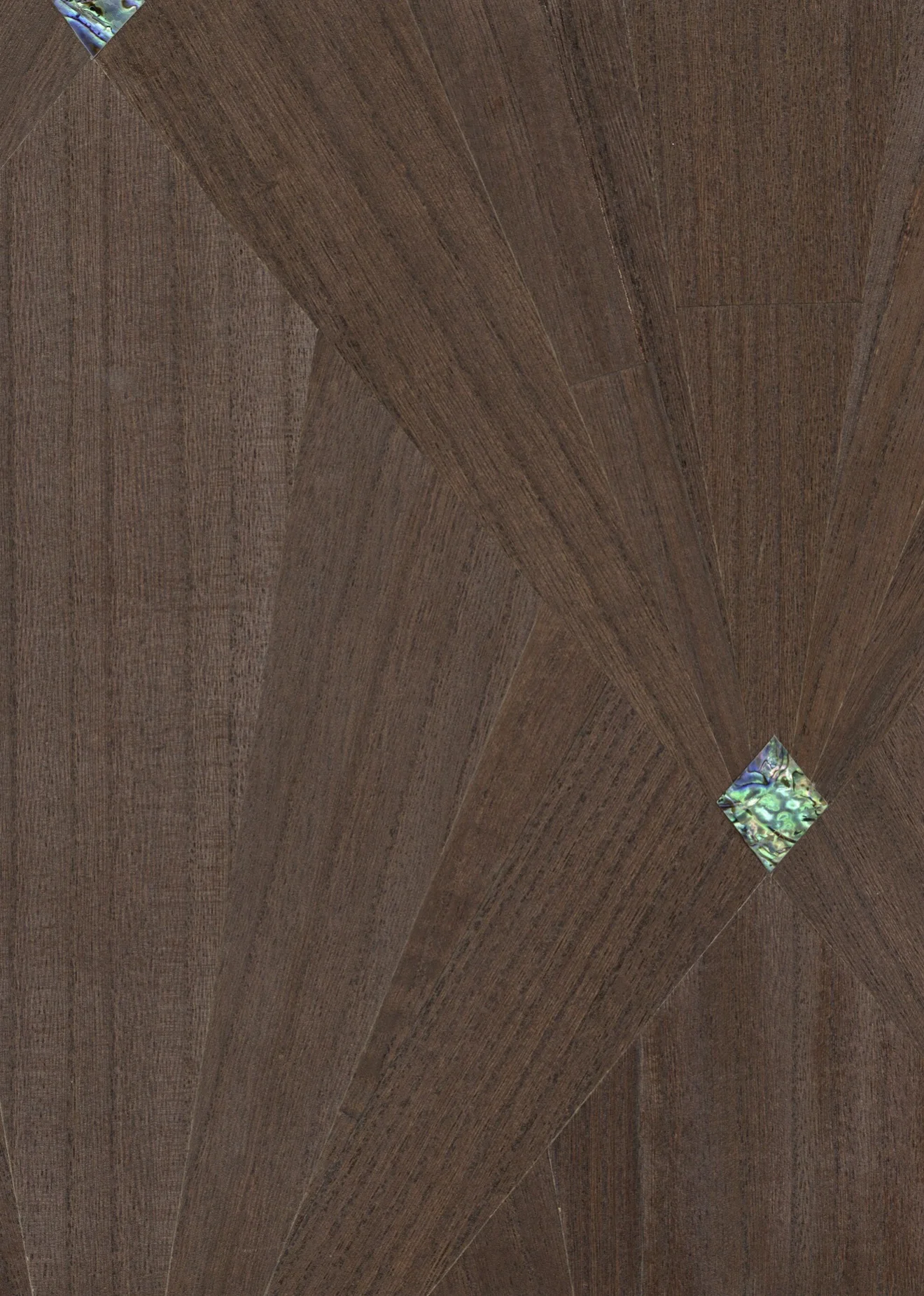 Close-up of Nocturne Inlay: dark brown Wood Veneer sections meeting at angles in a geometric composition, with small iridescent diamond-shaped accents