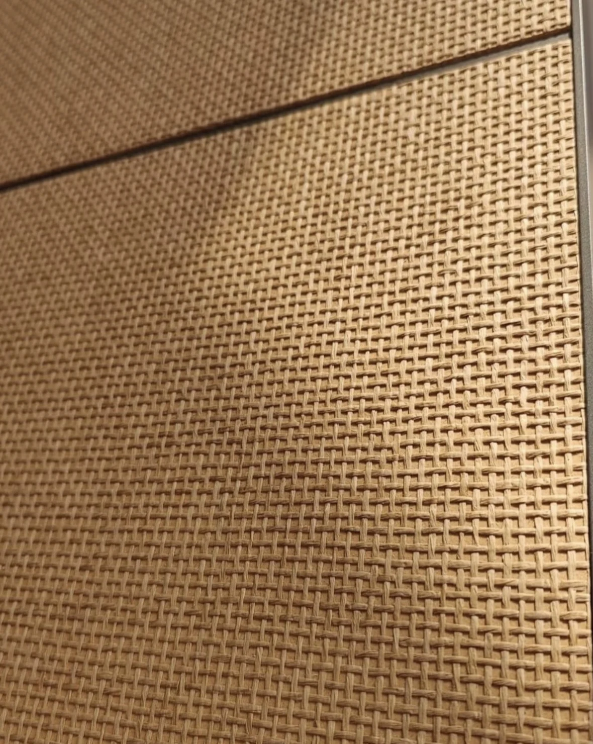 Drawer fronts finished with a tan jute wallcovering as decorative material inspiration